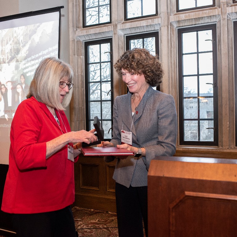 Laurie Burns McRobbie presents the medal to Maureen Biggers